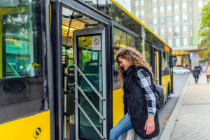 woman stepping on bus